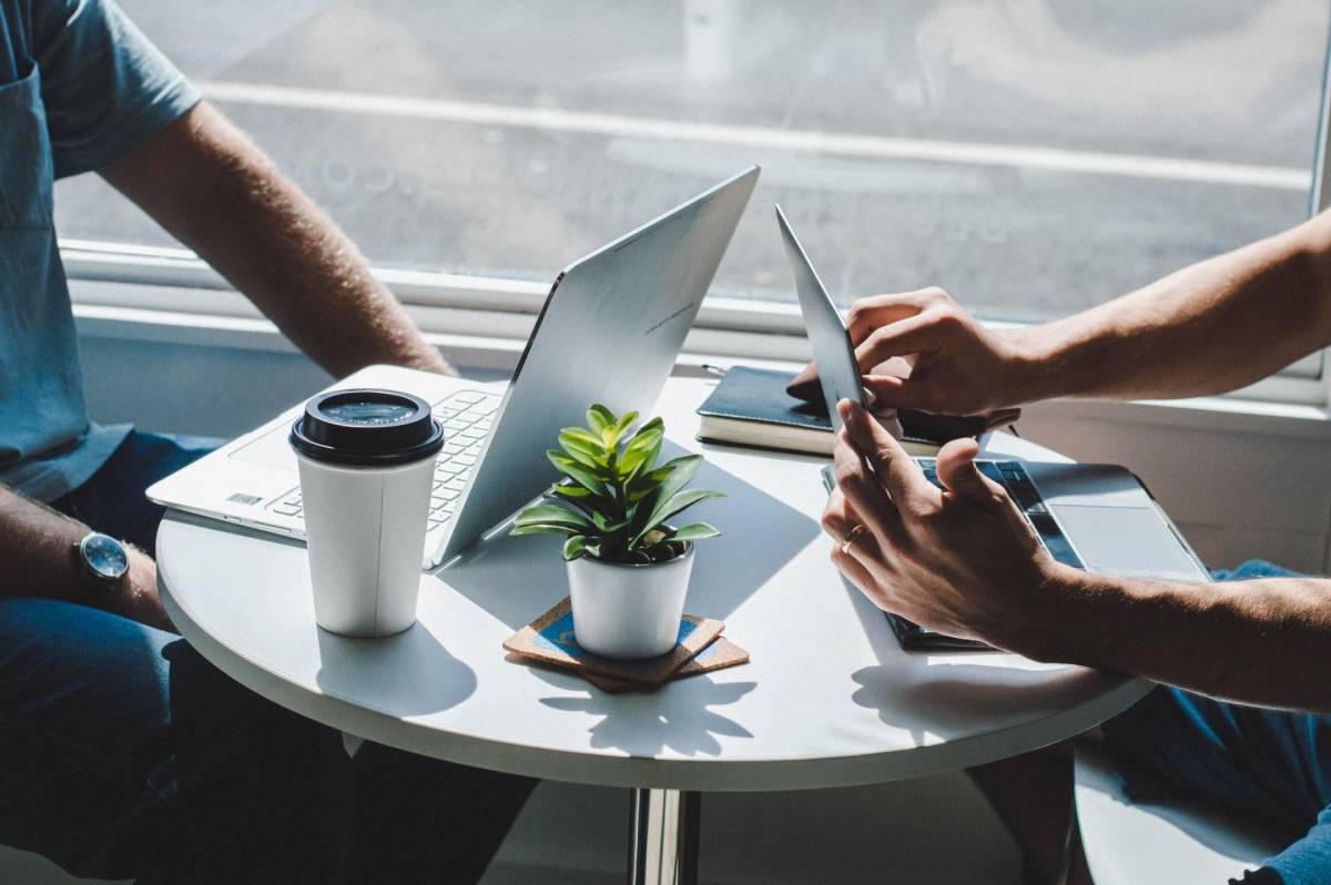 A picture of two business owners talking about business strategy over a cup of coffee.